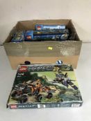 A box of four boxed Lego sets inc.