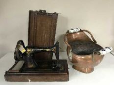 A vintage Singer hand sewing machine together with a copper coal bucket