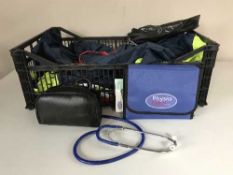 A box of hi-viz medical jackets, tens machine,