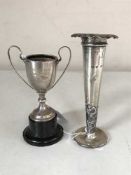 A silver trophy on stand and a silver rose flute