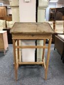 An antique pine clerk's desk on stand