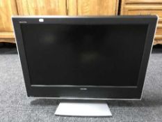 A Toshiba Regza 32 inch LCD TV with lead and remote