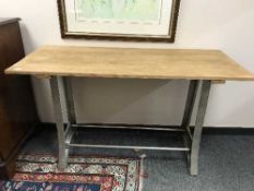 A reclaimed pine table on metal support