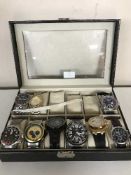 A watch display box containing nine Gents watches