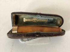 An amber cheroot holder with 15ct gold mount