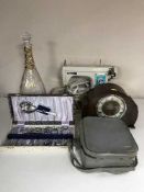A cased Newholme electric sewing machine together with an oak Bentime mantel clock,
