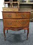An inlaid mahogany serpentine fronted chest drawers