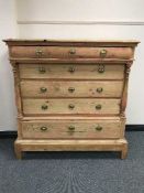 An antique pine five drawer chest with brass handles
