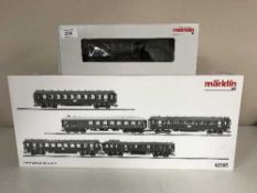 A Marklin 37960 steam locomotive together with a 42765 Express Train Passenger Car Set (HO Scale),