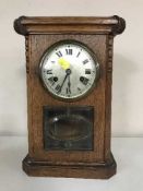 An Edwardian oak mantel clock with silvered dial