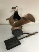 A copper coal bucket containing hearth brush, shovel,