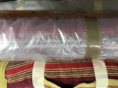 Six rolls of material together with a crate of leather pieces,