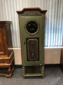 A painted pine cabinet on stand with porthole glass panel