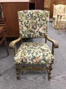 A carved oak and tapestry armchair