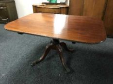 A Regency mahogany tilt-top breakfast table, on a turned four-way pedestal support,
