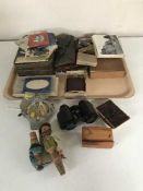 A tray of monochrome and colour photographs, wooden bottle stoppers, field glasses, AA badge etc.