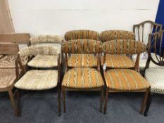 A set of four teak dining chairs and a pair of teak elbow chairs