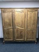 A French oak triple-door wardrobe.