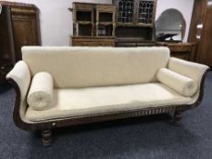 A Victorian inlaid mahogany framed scroll armed settee with two bolster cushions