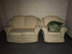 A green dralon settee and chair with loose covers