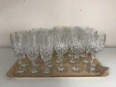A tray of lead crystal glasses and two Royal Doulton plates