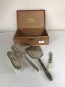 A three piece silver brush set in wooden box