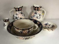 A six piece pottery blue and gilt with floral decoration toilet set