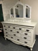 A white Country Corner fourteen drawer chest with triple mirror
