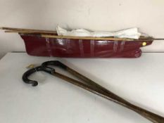 A wooden pond yacht together with two shepherd's crooks