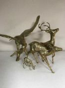 A large brass figure - eagle on branch and a three brass figures of deer