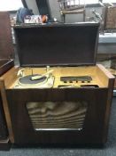A walnut Monarch radiogram together with a small quantity of lps,