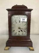 A mahogany cased mantel timepiece with silvered dial