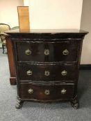 A late 19th century serpentine fronted three drawer chest