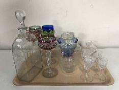 A tray of coloured lead crystal wine glasses, etched decanters, etc.