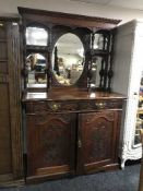 A heavily carved Victorian mirror backed sideboard