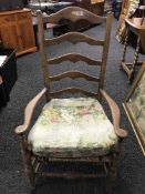An early 20th century rush seated pine armchair