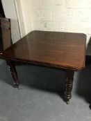 A late Victorian mahogany wind out dining table