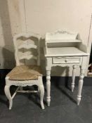 A white Country Corner bedside stand and rush seated chair