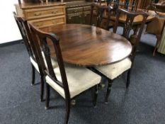 An inlaid pedestal dining table and four Edwardian chairs