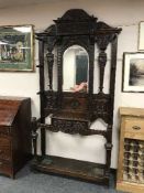 A Victorian carved oak mirror back hallstand,