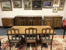 A French ten-piece oak dining room suite comprising of break-front sideboard,