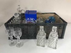 A basket of glass, decanters, drinking glasses,