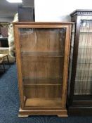 A teak effect display cabinet