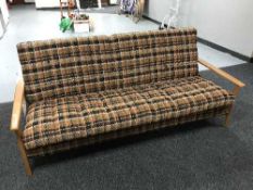 A mid 20th century teak framed bed settee
