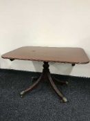 A reproduction mahogany breakfast table