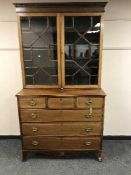 A George III style inlaid mahogany bookcase