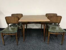 A walnut pull out table and four chairs