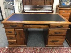 A plantation pine twin pedestal writing desk