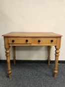 A Victorian pine side table fitted with two drawers