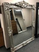 A large ornate silvered mirror